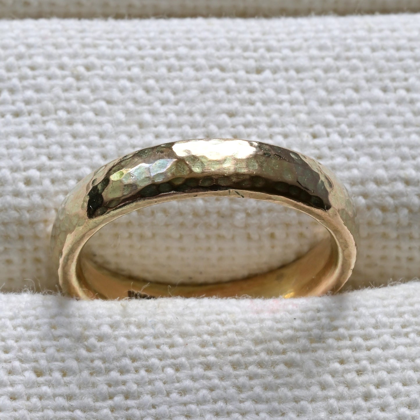 simple 9ct yellow gold wedding band pictured on a white background.