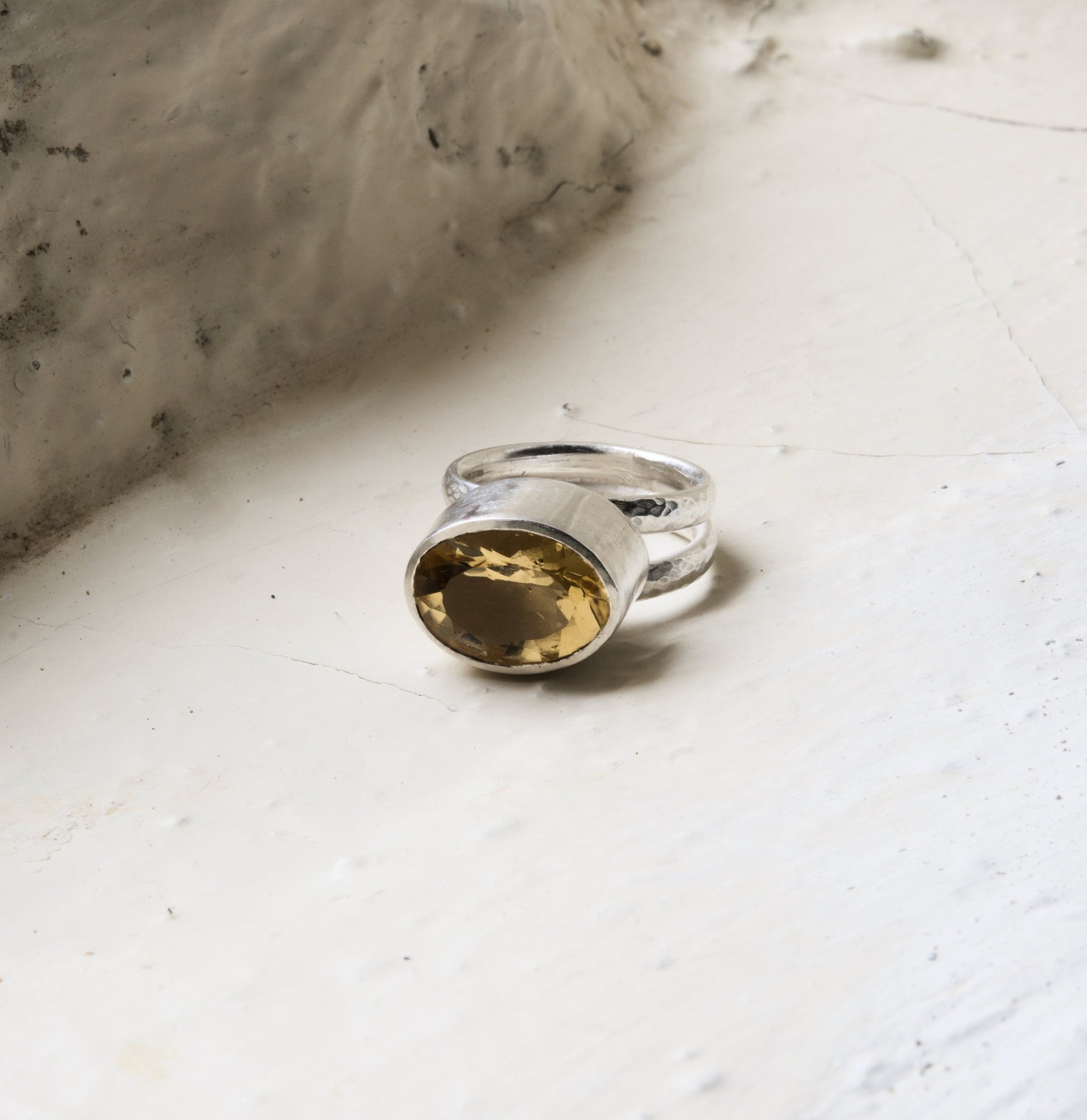 citrine and silver statement ring pictured on a white background.