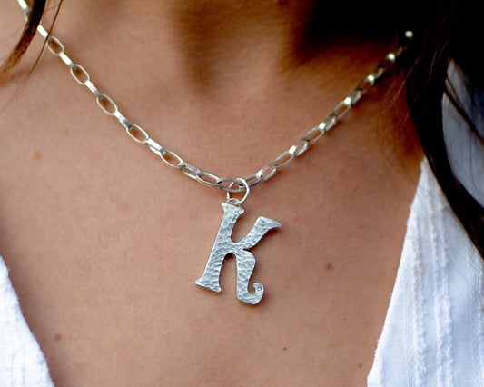 Katie wearing the diamond sterling silver letter pendant. Handmade fine jewellery by Madeleine.